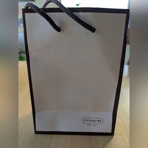 Coach, Glossy White Shopping Bag with Brown Cord Handles Red Inside, 2001.